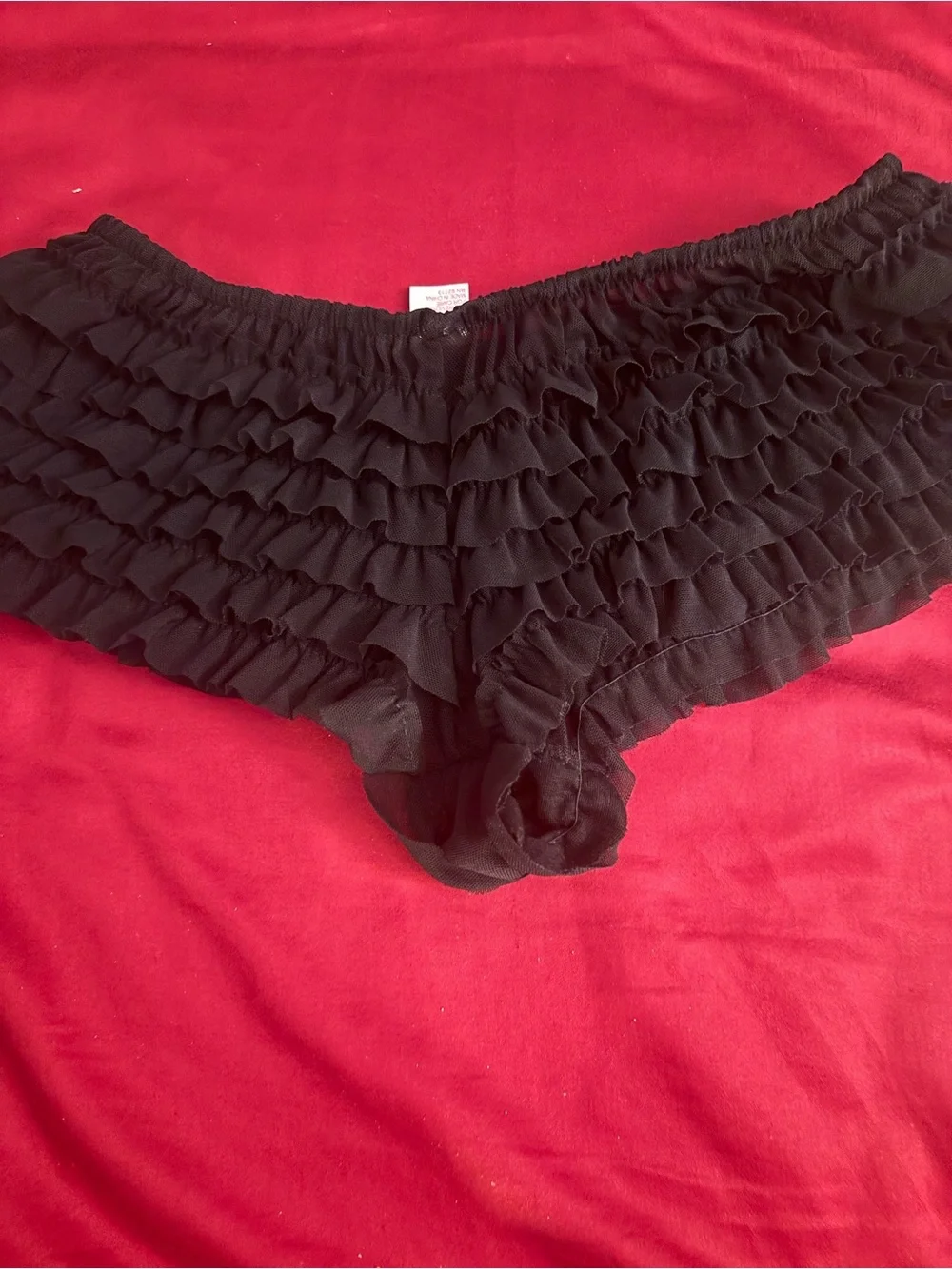 Black ruffled lingerie set with ruffed panty and sheer top.  Top i